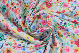 Swirled swatch moth floral fabric (white fabric with small tossed floral and greenery allover in pink, orange, yellow, blue, green with tossed green/teal painted moths small)