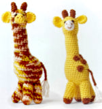 Completed Amigurumi giraffes (one yellow/brown with white nose and tail, one multi with yellow nose and tail)