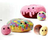 Completed Amigurumi donuts (beige donut with multi coloured glaze, brown donut with pink glaze, mini donut holes)