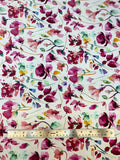 Flat swatch knit material in botanical white (purple and blue flowers with green and yellow leaves on white with a watercolour look)