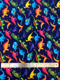 Flat swatch knit material in colourful dino (yellow, green, blue, pink, orange cartoon dinosaurs on dark blue)