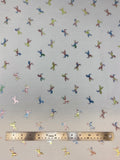 Flat swatch double gauze fabric with small metallic/rainbow iridescent unicorns on white