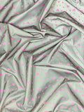 Crinkled swatch grey reflective fabric with tiny pink heart doodles tossed allover