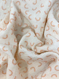 Crinkled swatch double gauze fabric with small faint rainbows on white