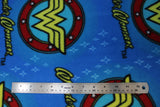 Flat swatch Wonder Woman licensed print on fleece (text, circular logo on blue)