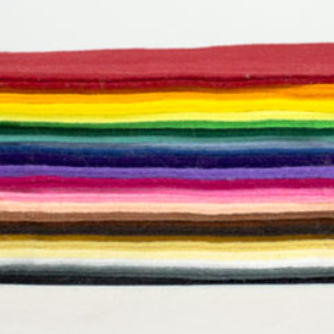 A side-view of a stack of felt in a rainbow of shades