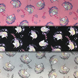 Group swatch cartoon unicorn head printed fabric in various colours
