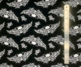 Flat swatch Skulls Black fabric (black fabric with tossed white skulls and roses allover - skull heads have expanded wings behind them)