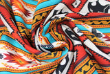 Swirled swatch Terracotta Bears fabric (horizontal striped southwest style fabric with geometric shapes and bear silhouettes/paws allover in red, orange, teal and natural shades)