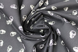 Swirled swatch 100% Organic Cotton fabric (black fabric with small white skull heads)