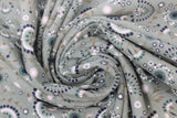 Swirled swatch floral printed fabric in flowers sage (faded sage green fabric with assorted white/grey/black/brown floral heads and stems tossed)