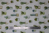 Flat swatch Cactus Verde fabric (white fabric with subtle grey geometric design background and scattered green cacti in pots/vases)
