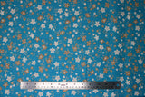 Flat swatch Blue Floral Toss fabric (medium blue fabric with small tossed cream and tan floral heads and stems allover)