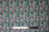 Flat swatch Light Blue fabric (pale turquoise blue green fabric with busy tossed illustrative style floral and greenery allover in white, yellow, pink, green)