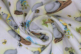 Swirled swatch honey bear fabric (white fabric with tossed grey cartoon bears in various poses, bees and honey pots, and tree branches)