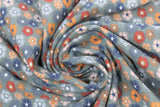 Swirled swatch floral printed fabric in print flowers multi (faded green/grey fabric with small flower heads in grey/blue/orange/red colours)