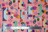 Flat swatch Cat Race fabric (pale coral pink with busy tossed doodle style cats in cars, tossed flowers and birds all in bright colours)