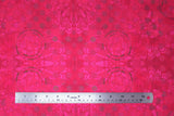 Flat swatch fuchsia medallion fabric (fuchsia coloured fabric with pink floral appliques and purple polka dots and grey circular paint look marks)