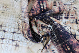 Swirled swatch London gridlock fabric (neutral coloured fabric with brown and black distressing look/puddle style pattern and faint black lettering)