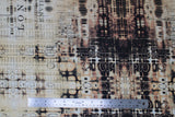 Flat swatch London gridlock fabric (neutral coloured fabric with brown and black distressing look/puddle style pattern and faint black lettering)
