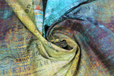 Swirled swatch Piano Sorte fabric (blue and green distressed look fabric with colour marbling and subtle black sheet music and text in background)
