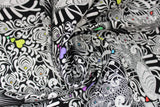 Swirled swatch linework themed fabric in tall tails (black fabric with intricate white birds/peacock design, multi-coloured hearts)