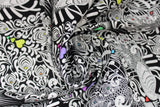 Swirled swatch linework themed fabric in tall tails (black fabric with intricate white birds/peacock design, multi-coloured hearts)