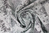 Swirled swatch linework themed fabric in sketchy (animal and floral doodles, pandas, zebras, skunks, etc. with hearts and stars printed on white grid paper look fabric)