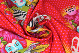 Swirled swatch The Red Queen fabric (red fabric with tiny pink hearts stripe background with large full colour queen of hearts interpretation character with pink hair, blue skin, and striped outfit/crown with orange sunburst behind queen and white, pink, orange fluer de lis style filigree beneath and "Q" with heart)