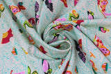 Swirled swatch sea of tears fabric (white fabric with light blue wave/water look lines allover and tossed colourful characters and emblems swimming: alice in wonderland inspired - alice character, dodo bird, duck, tea cup, pocket watch, fan, etc.)