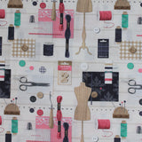 Square swatch couture fabric (off white fabric with faint grey stripes and tossed sewing elements scissors, buttons, thread, pins, needles, cushions, wooden forms, etc. in neutrals, black and pink/turquoise colourway)