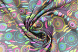 Swirled swatch reve fabric (dark grey fabric with bright and pastel coloured dream catchers in various sizes and styles in yellow, green, blue, pink, orange, purple colourway)