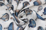Swirled swatch nacelle fabric (off white fabric with tossed blue and beige hot air balloons in vintage style, faint circular designs in background)