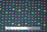 Flat swatch Scarab fabric (dark blue/green fabric with lines of multi coloured beetle bugs yellow bodies with pink, grey, green, teal, blue, purple, pink, orange shells)
