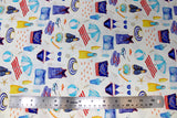 Flat swatch of cartoon beach/swim printed fabric on white