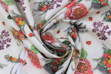 Swirled swatch Coleope fabric (off white/beige fabric with large tossed pink and red floral with greenery, large floral decorated insects: bees, dragonflies, beetles and tossed red lady bugs)