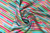 Swirled swatch pencils fabric (purple/grey fabric with lines of coloured pencils in blue, green, red, pink tones looking as though they are shooting across the fabric)