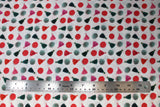 Flat swatch of handmade print fabric in tassels and pom poms