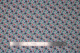 Flat swatch small floral fabric (bright aqua fabric with small collaged floral heads allover in purple, red, pink)