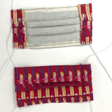Front and back view of mask with white elastic ear loops (pale red mask with rows/lines of feathers alternating from a row of purple then a row of pink/yellow)