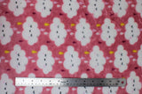 Flat swatch (side 1) Nimbus fabric (blush pink fabric with large white clouds with cartoon closed-eyed faces and rain drops dripping in white, pink, purple and yellow shades)