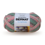A ball of Bernat Symphony yarn in shade Seashell (pale cream and grey, pink and turquoise green)