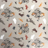 Square swatch The Lion King fabric (light grey fabric with "Wild Ones" text and coloured character silhouettes in yellow/green/brown/white/red shades)