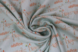 Swirled swatch monkey see monkey do fabric (pale blue fabric with cartoon monkeys in light brown/grey with stripes look hanging from tree branches)