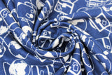 Swirled swatch Around the World fabric (dark blue fabric with white suitcase outlines and planet earth's with dotted directional lines connecting all in busy collage style)