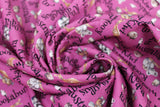 Swirled swatch Australia fabric (magenta fabric with busy tossed black text allover reading Australian creature names "Koala" "Kiwi" etc. and small tossed Australian animal friends)