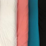 Closeup of a row of bamboo french terry bolts, showing off-white, coral, turquoise and black shades