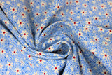 Swirled swatch Blue Daisies fabric (tiny blue floral heads tossed allover with medium sized white daisy heads with burgundy centers)