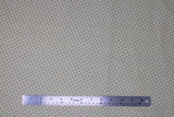 Flat swatch tan cross marks fabric (off white fabric with tiny tan coloured crosses/x's allover)