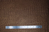 Flat swatch copper coloured gator style textured vinyl fabric